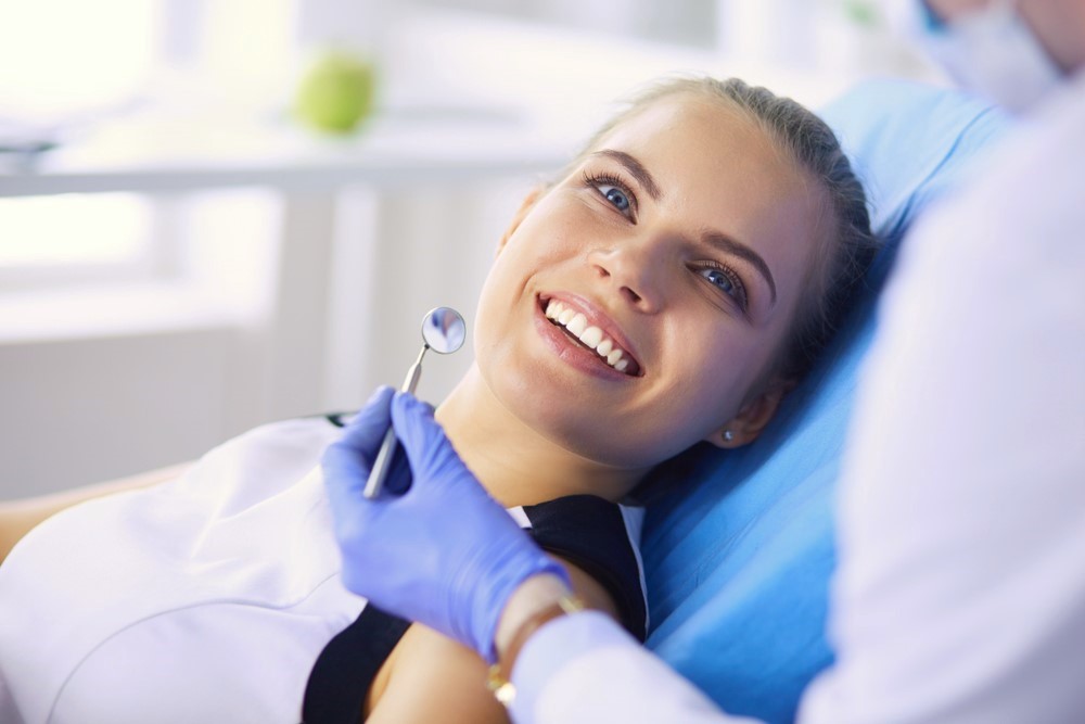 teen girl smiling sitting in dentist chair, getting dental work done, dentist in Baytown, TX